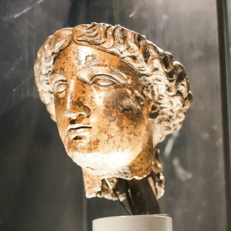 An elegant bronze bust sculpture displayed on a stand.